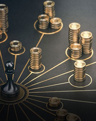 Golden coins and a chess piece on a black background - Big Catch Consulting